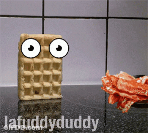 A Waffle With Googly Eyes Is Standing Next To Bacon GIF