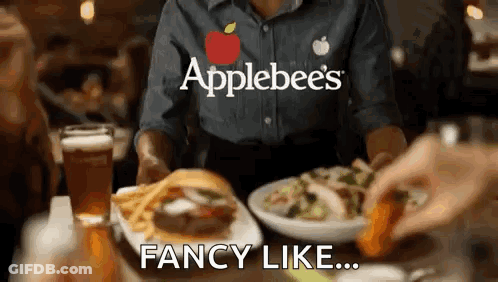 A Waitress At Applebee 'S Is Serving A Hamburger And French Fries GIF