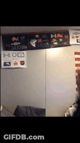 A Wall With A Bunch Of Under Armour Posters On It GIF
