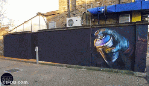 A Wall With A Painting Of A Hand Holding A Spray Can With The Word Energy Written On It GIF