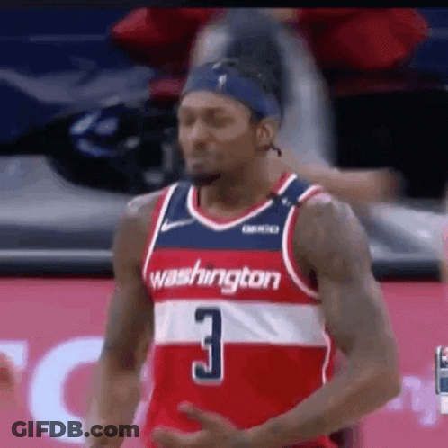 A Washington Wizards Basketball Player Is Standing On The Court During A Game . GIF