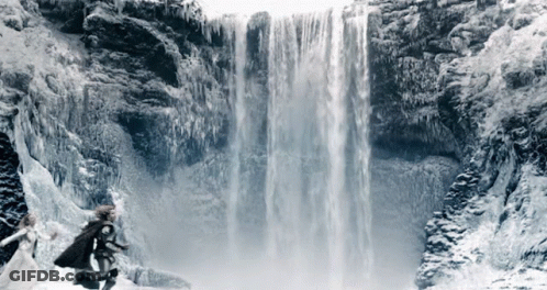 A Waterfall Is Surrounded By Ice And Snow GIF