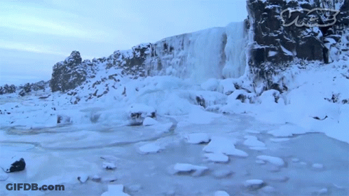 A Waterfall Is Surrounded By Snow And Ice With A Watermark That Says Cnn GIF