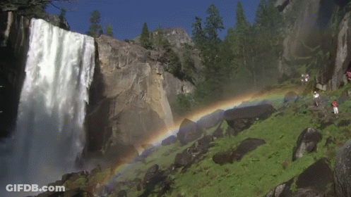 A Waterfall With A Rainbow Behind It GIF