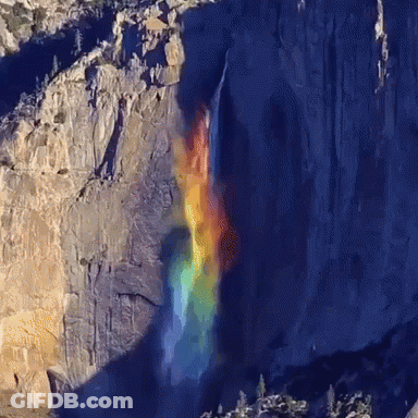 A Waterfall With A Rainbow In The Background GIF