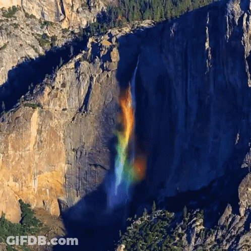 A Waterfall With A Rainbow In The Middle GIF