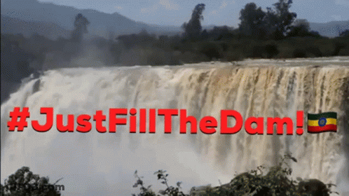 A Waterfall With The Words #Justfill The Dam Written In Red GIF