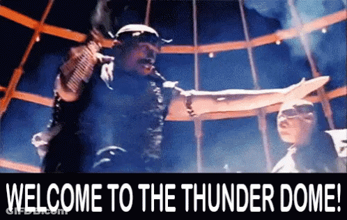 A Welcome To The Thunder Dome Sign With A Man In The Background GIF