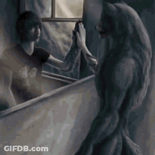 A Werewolf Is Standing In Front Of A Mirror Looking At Her Reflection GIF