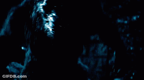 A Werewolf With Its Mouth Open In The Dark GIF