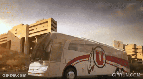 A White And Red Bus With The Letter U On The Side GIF