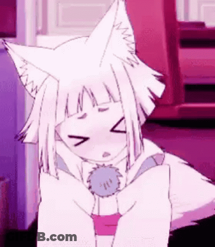 A White Anime Girl With Fox Ears Is Sitting On A Bed . GIF