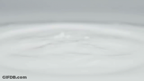 A White Apple Iphone Is Floating On A White Surface GIF