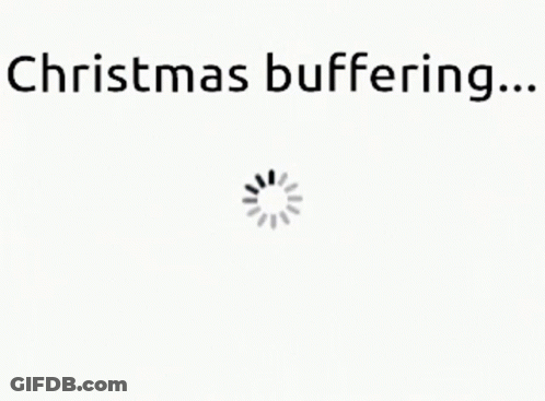 A White Background With The Words `` Christmas Buffering ... '' And A Loading Spinner . GIF