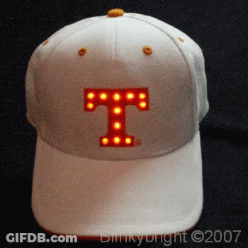 A White Baseball Cap With The Letter T Lit Up GIF
