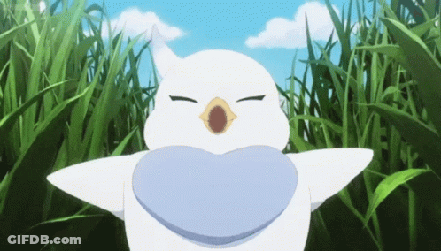 A White Bird With A Heart Shaped Mouth Is Standing In A Field Of Grass GIF