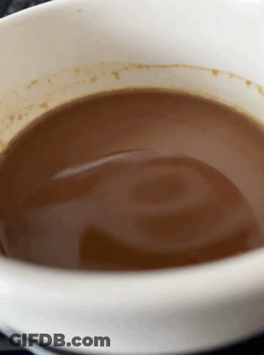A White Bowl Filled With Brown Liquid With A Swirl In It GIF