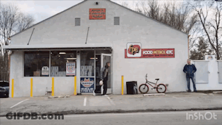 A White Building With A Red Sign That Says Food Patrol Etc GIF