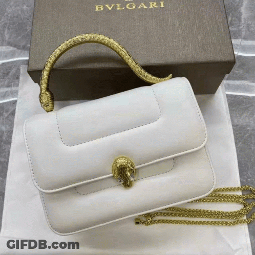 A White Bvlgari Purse With A Gold Handle GIF