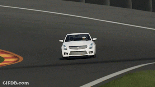 A White Cadillac Is Driving Down A Road GIF