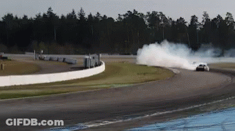 A White Car Is Drifting On A Race Track GIF