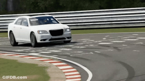 A White Car Is Driving Around A Curve On A Race Track GIF