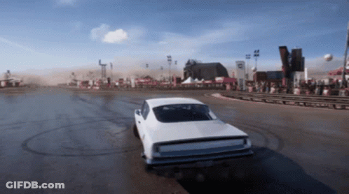 A White Car Is Driving Down A Dirt Road With A Sign That Says ' R ' On It GIF