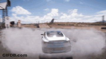 A White Car Is Driving Down A Dirt Road With Smoke Coming Out Of It GIF