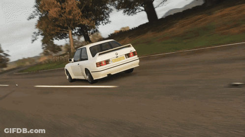 A White Car Is Driving Down A Road And Has A License Plate That Says ' Sd ' On It GIF