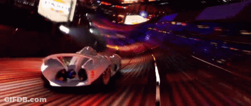 A White Car Is Driving Down A Road At Night With A Sign That Says Chevrolet In The Background GIF