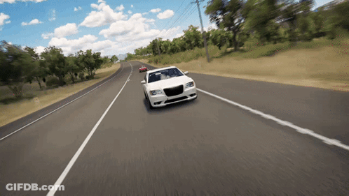 A White Car Is Driving Down A Road GIF