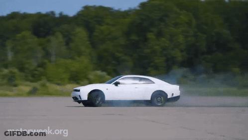 A White Car Is Driving Down A Road With Motorweek.org Written On The Bottom Right GIF