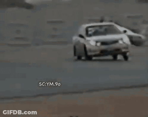 A White Car Is Driving Down A Road With The Words Sc Ym 90 On The Bottom Right Corner . GIF