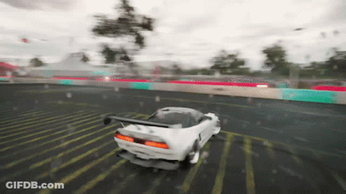 A White Car Is Driving Down A Wet Road In The Rain GIF