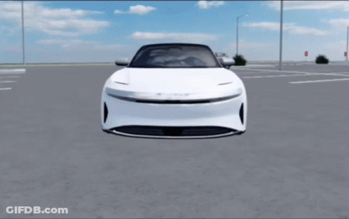 A White Car Is Parked In A Parking Lot With A Blue Sky In The Background GIF