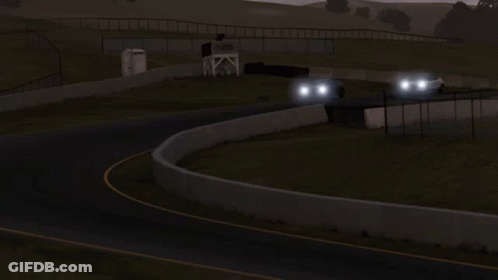 A White Car With A Black Roof Is Driving Down A Road At Night GIF