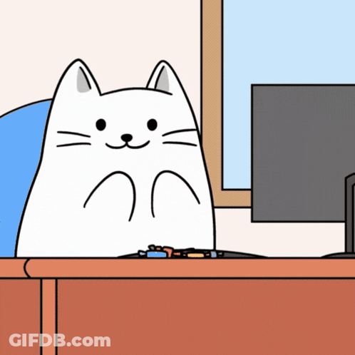 White Cat Sitting At Desk In Front Of Computer GIF