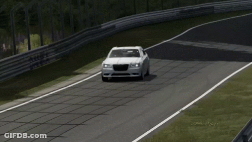 A White Chrysler Car Is Driving Down A Track GIF