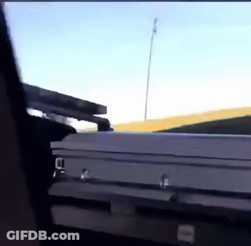 A White Coffin Is Sitting In The Back Of A Truck GIF