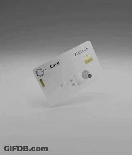 A White Credit Card Is Floating In The Air On A Gray Surface . GIF