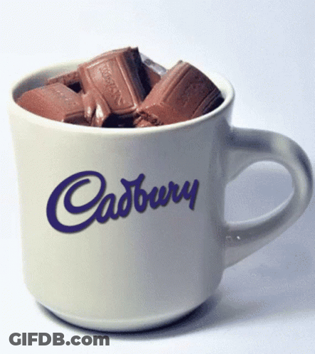 A White Cup With Cadbury Written On It Filled With Chocolate GIF