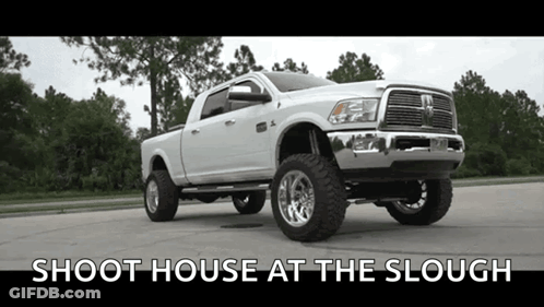 A White Dodge Ram Truck Is Parked On The Side Of The Road . GIF