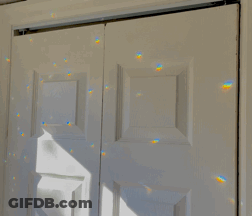 A White Door With A Reflection Of A Rainbow GIF