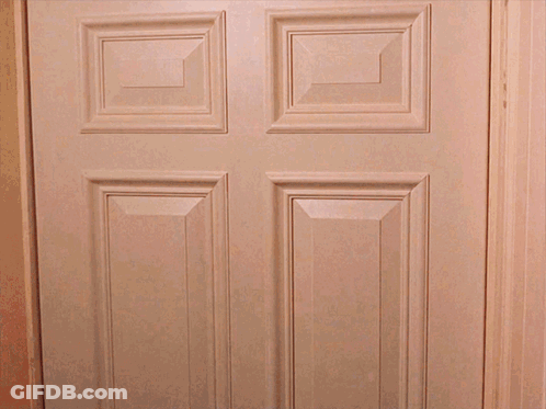 A White Door With Four Squares On It Is Open To A Dark Room GIF