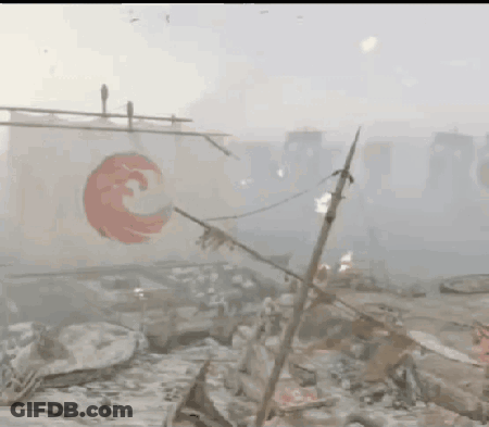 A White Flag With A Red Circle On It Is Hanging From A Pole In A Foggy Area . GIF
