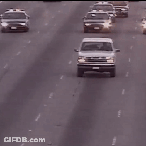A White Ford Truck Is Driving Down A Highway With A License Plate That Says ' Lc ' GIF