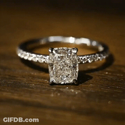 A White Gold Ring With A Square Diamond In The Center GIF