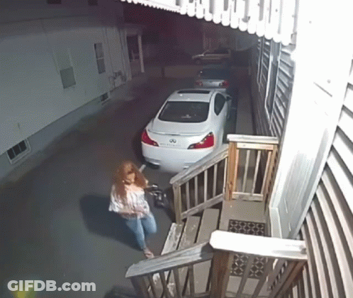 A White Infiniti Is Parked In A Driveway Next To Some Stairs GIF