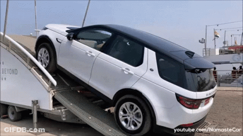 A White Land Rover Is On A Ramp That Says Beyond Ur GIF