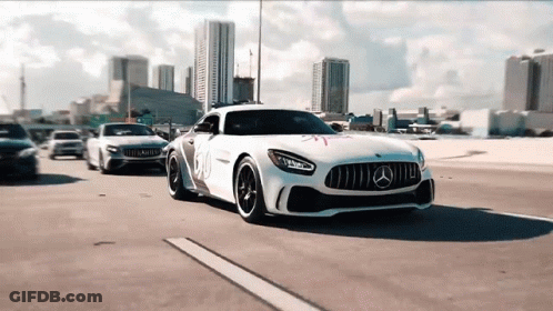 A White Mercedes Is Driving Down A Highway Next To Other Cars GIF